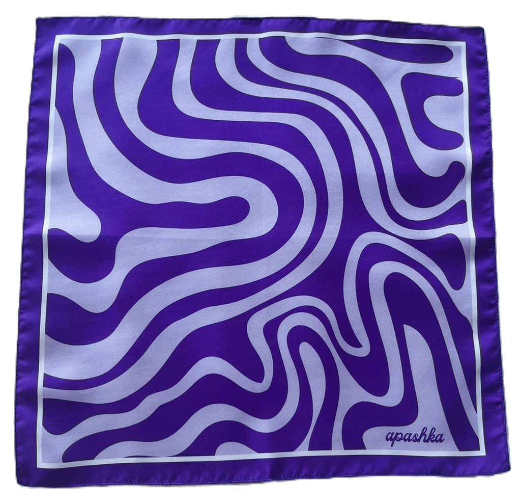 Flat, full-view layout of the apashka Acid Wave square silk scarf, displaying its trippy purple and lavender swirling wave pattern, solid border, and cursive brand logo in the corner.
