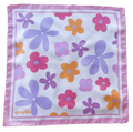 A flat lay view of the apashka Fiori Fuori silk bandana showing the complete retro floral pattern and light pink border frame.