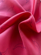 Close up of Red Hot Chili Apashka silk twill fabric folds showing the crimson texture and chili pepper print.
